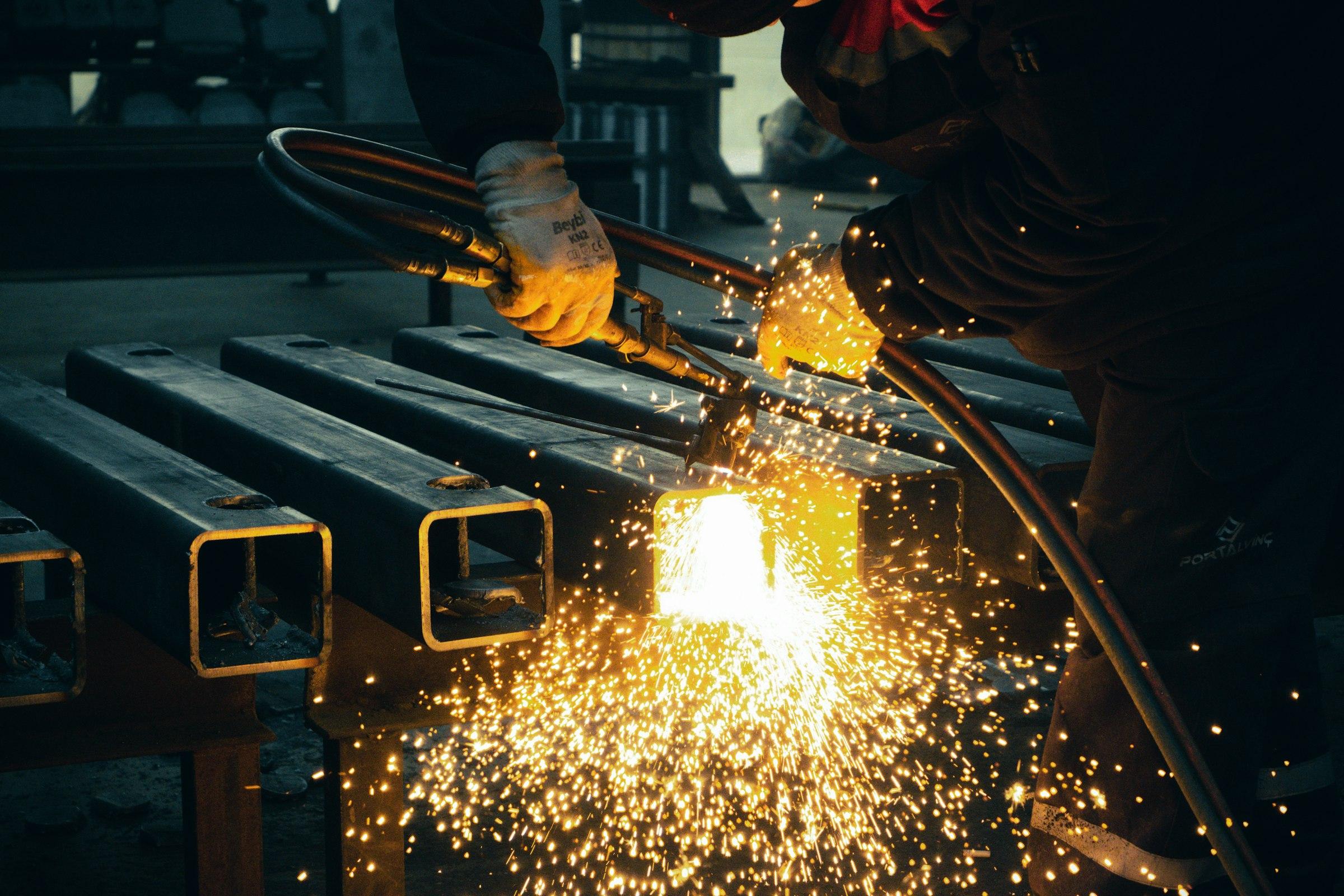 Steel sections being cut with a torch in the workshop