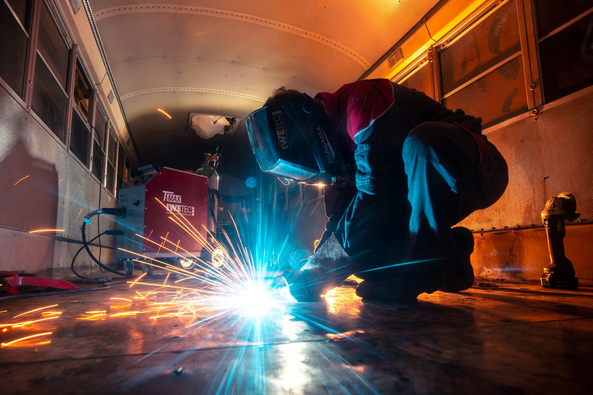 A welder at work inside a steel module
